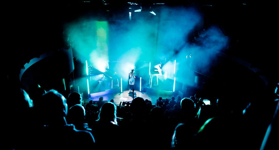 Hundreds on stage with visual in background