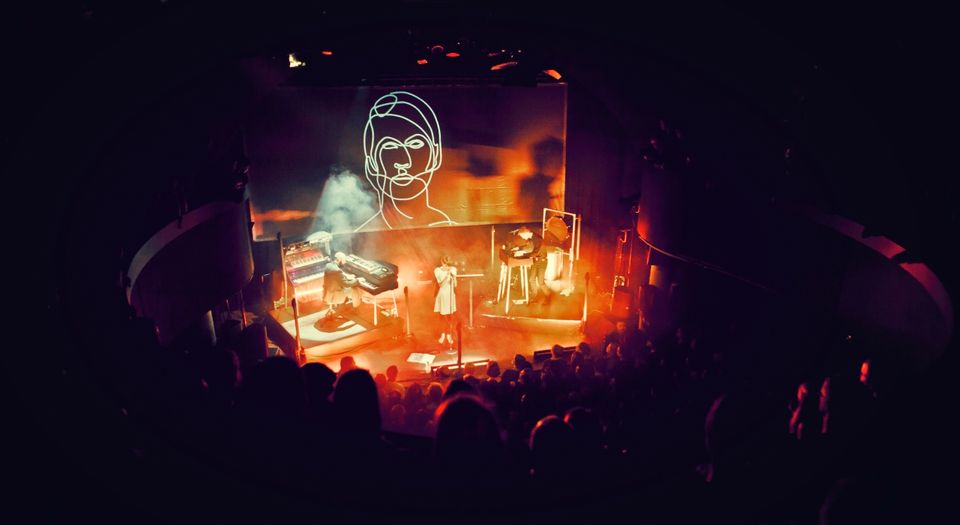 Hundreds on stage with visual in background